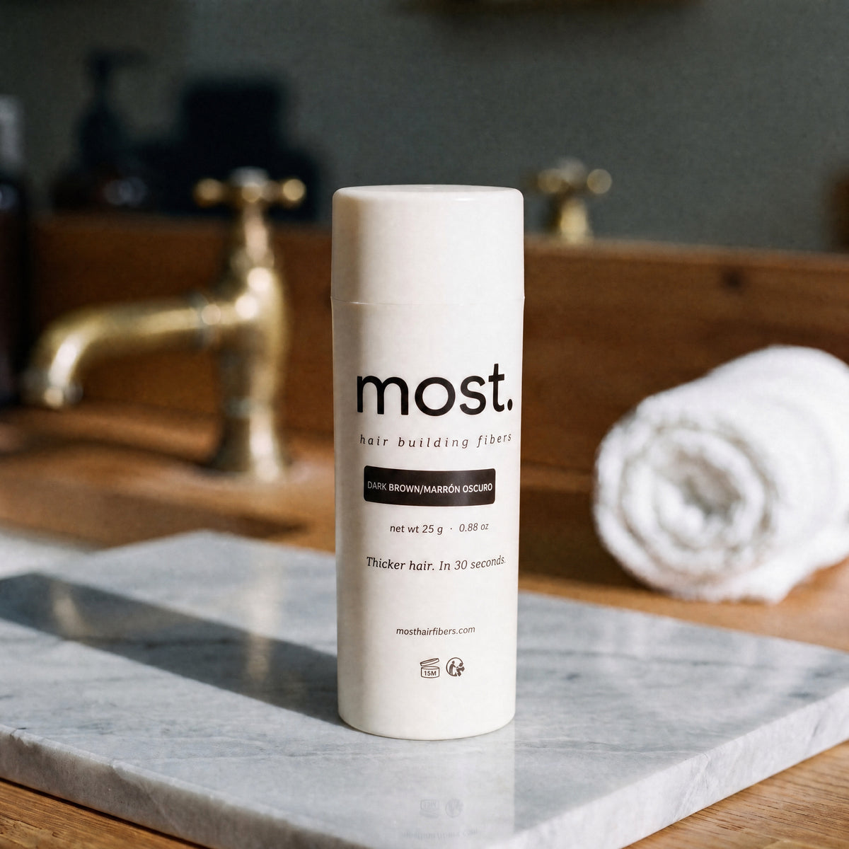 most. hair building fibers bottle on a marble barbershop counter