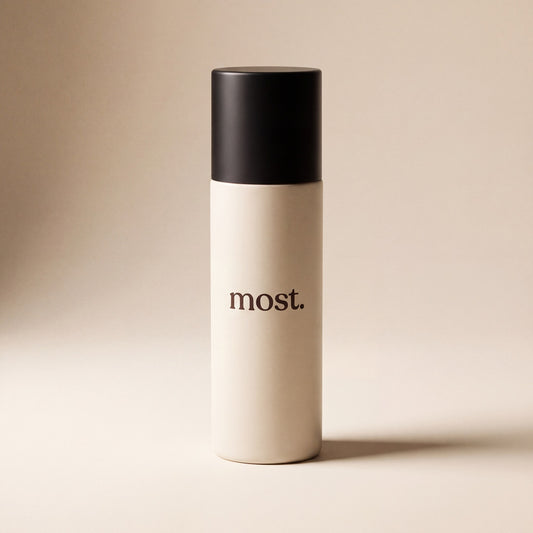A bottle of most. AnchorSet Spray with its matte black cap