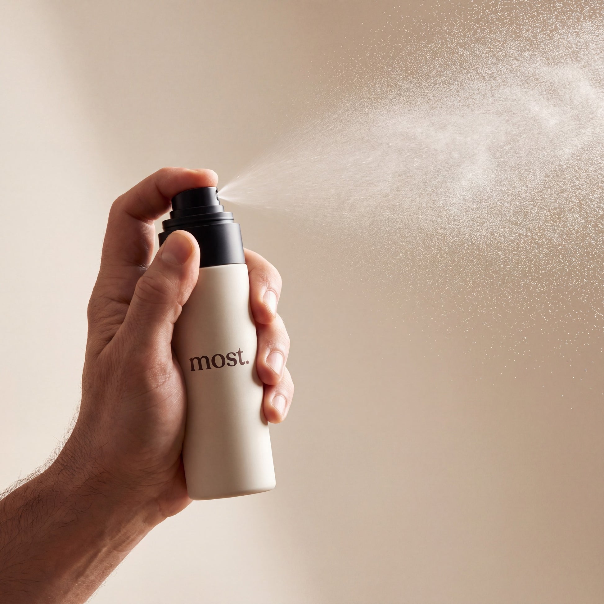 A hand spraying most. AnchorSet, releasing a fine even mist
