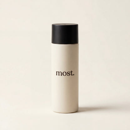 most. hair fibers bottle on a cream backdrop