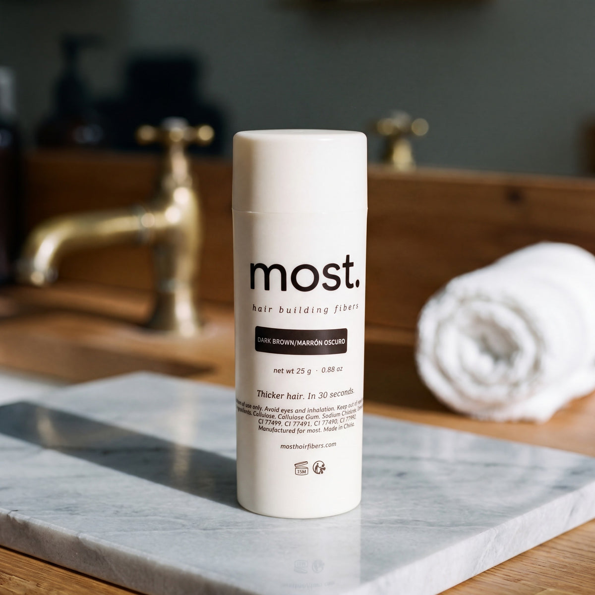 most. hair building fibers bottle on a marble barbershop counter